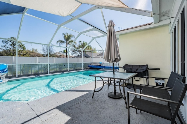 view of swimming pool with a fenced in pool, fence, glass enclosure, and a patio area