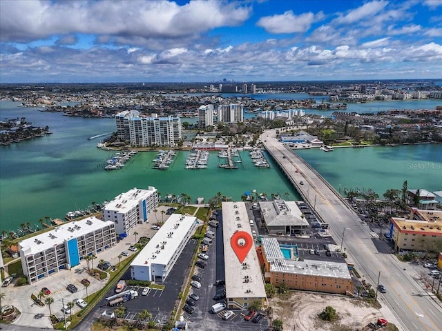 drone / aerial view featuring a view of city and a water view