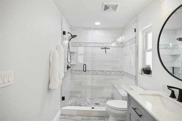 full bathroom with a stall shower, visible vents, vanity, and toilet