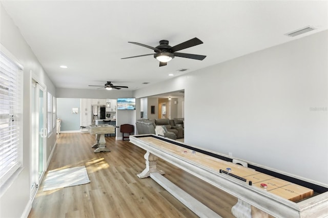 interior space with baseboards, wood finished floors, visible vents, and recessed lighting