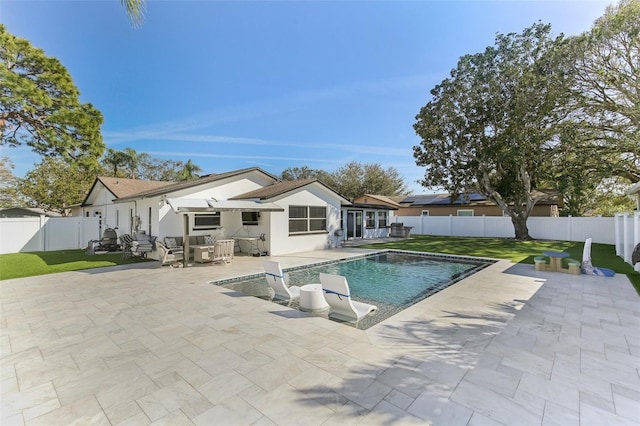 view of swimming pool with a patio area, a fenced backyard, a lawn, and a fenced in pool