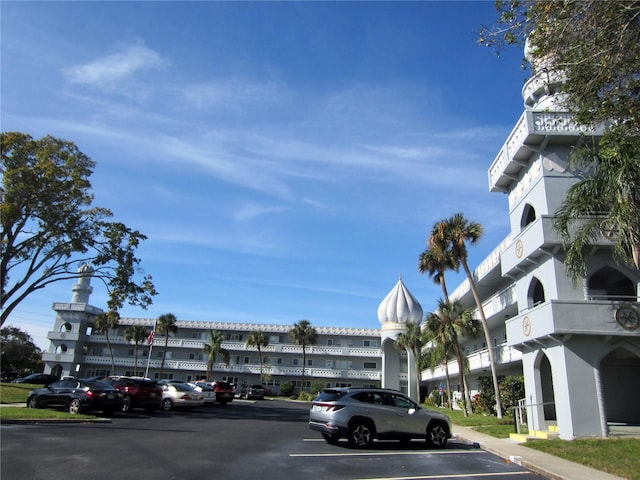 view of building exterior with uncovered parking