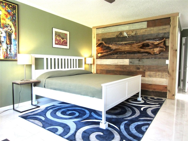 bedroom with wooden walls and a textured ceiling