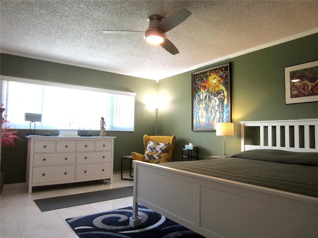 bedroom featuring light tile patterned floors, ceiling fan, ornamental molding, and a textured ceiling