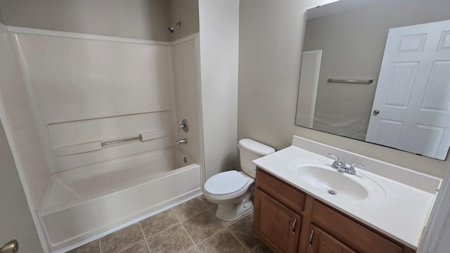 bathroom featuring toilet, tile patterned flooring, washtub / shower combination, and vanity