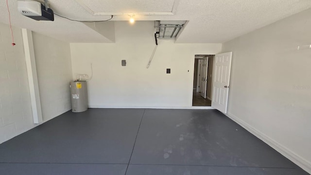 garage featuring baseboards, a garage door opener, and electric water heater