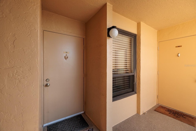 property entrance featuring stucco siding