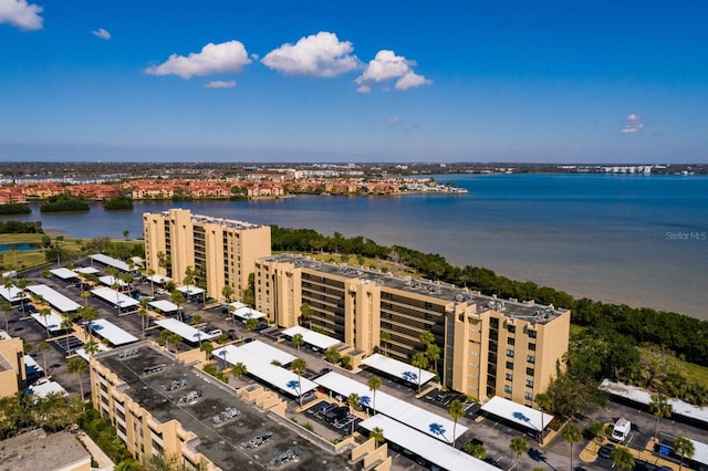 birds eye view of property featuring a water view and a city view