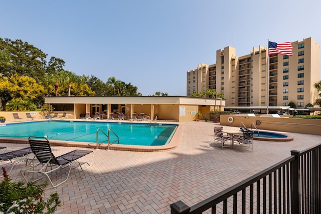 community pool featuring a patio area and fence