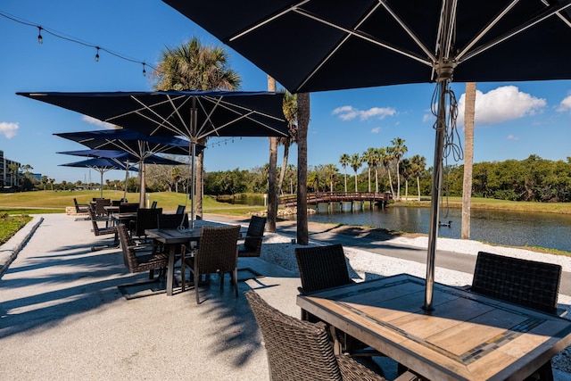 view of patio / terrace featuring outdoor dining space and a water view