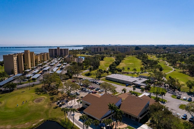 birds eye view of property with a view of city, view of golf course, and a water view