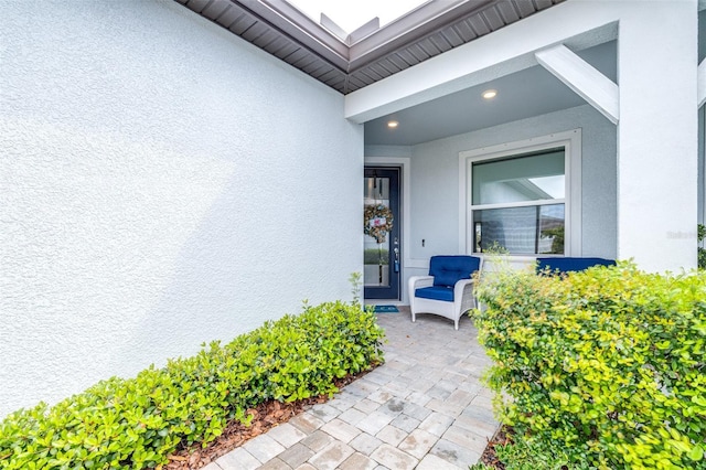 property entrance with stucco siding