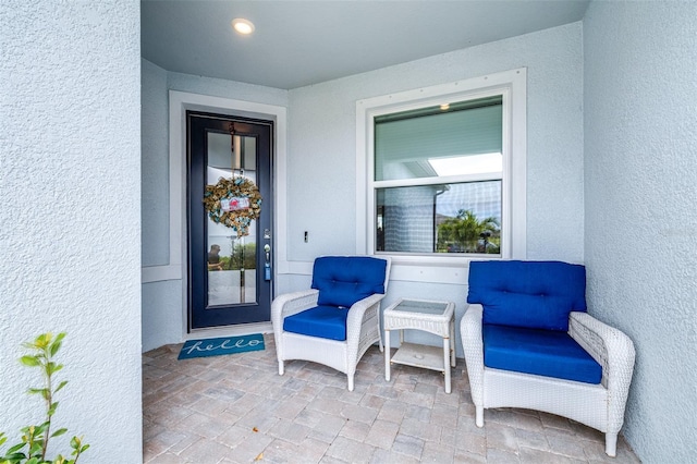 view of exterior entry with stucco siding