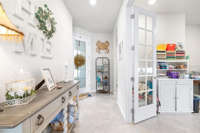 interior space with recessed lighting, baseboards, light tile patterned flooring, and french doors