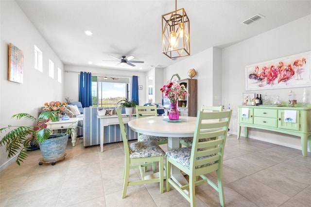 dining room with light tile patterned floors, recessed lighting, ceiling fan with notable chandelier, visible vents, and baseboards