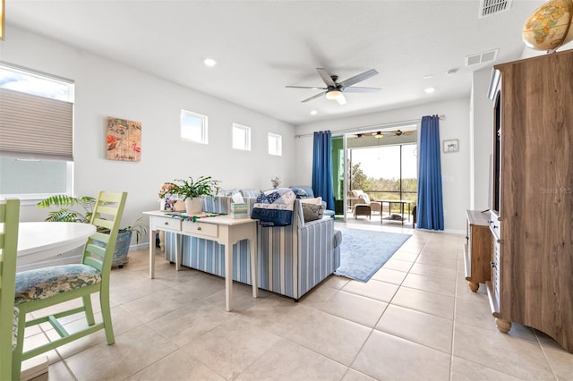 living area featuring light tile patterned floors, visible vents, and recessed lighting