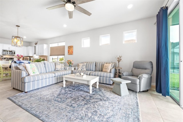 living area featuring light tile patterned floors, a ceiling fan, and recessed lighting