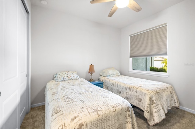 bedroom with carpet floors, a closet, a ceiling fan, and baseboards