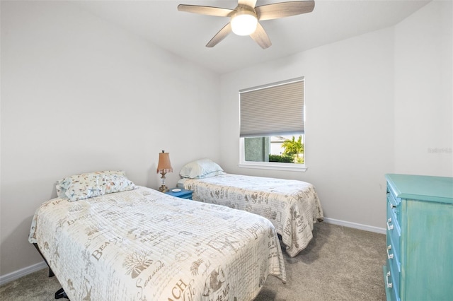 carpeted bedroom featuring baseboards and a ceiling fan