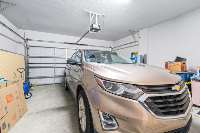 garage with electric panel and a garage door opener