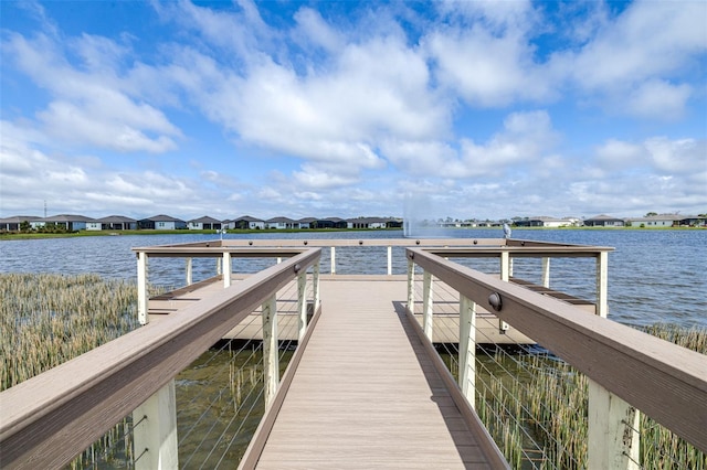 view of dock with a water view and a residential view