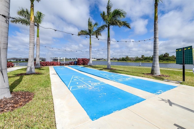 surrounding community with shuffleboard and a lawn