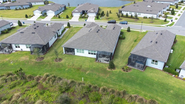 bird's eye view with a water view and a residential view