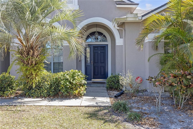 entrance to property featuring stucco siding