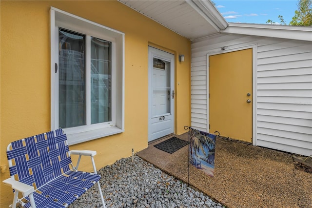 doorway to property with stucco siding