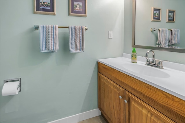 bathroom with tile patterned flooring, baseboards, and vanity