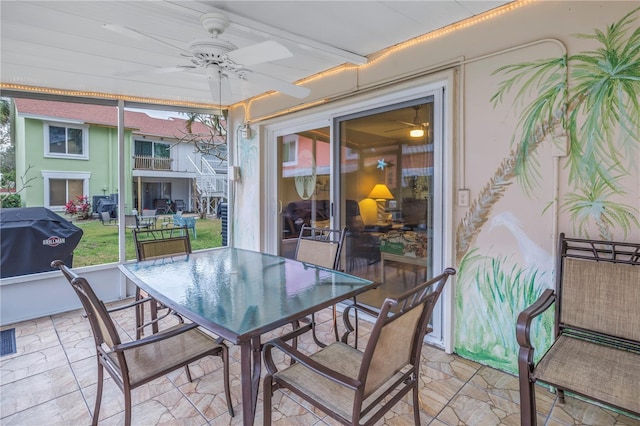 sunroom / solarium featuring ceiling fan