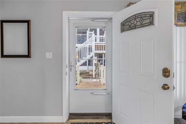 doorway to outside featuring baseboards