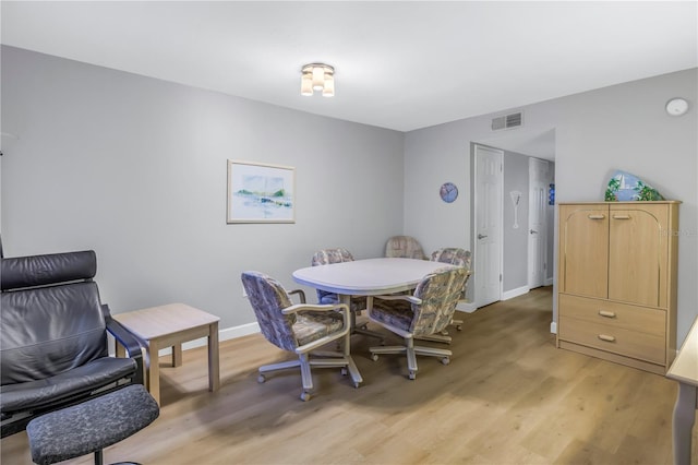 dining space with baseboards, visible vents, and light wood-style floors