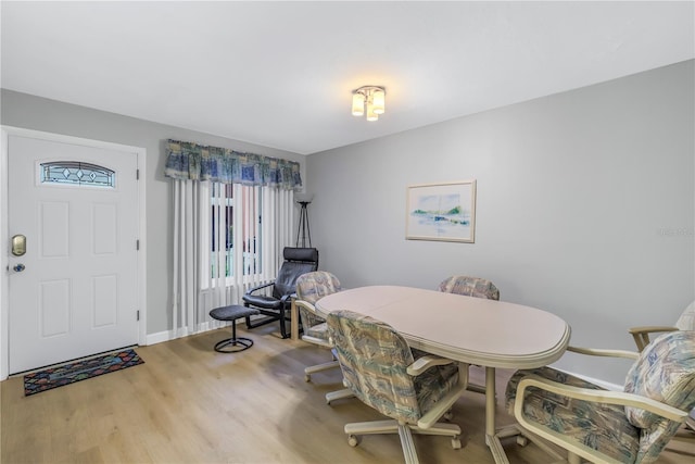 dining area with wood finished floors and baseboards