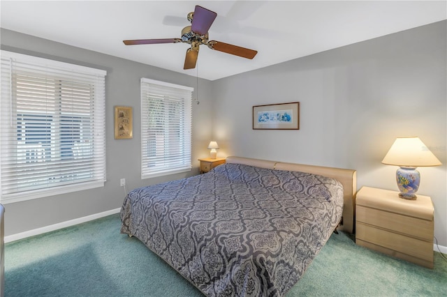 carpeted bedroom featuring ceiling fan and baseboards