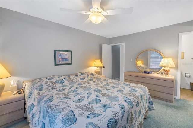 bedroom with light colored carpet, ceiling fan, and baseboards