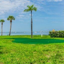 surrounding community featuring a yard and a water view