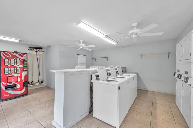 community laundry room with ceiling fan, separate washer and dryer, stacked washer / drying machine, and light tile patterned flooring