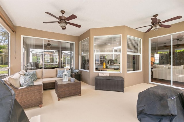 sunroom featuring a wealth of natural light and a ceiling fan