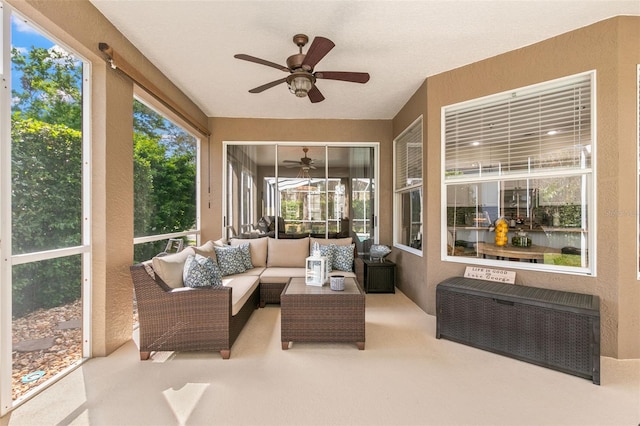 sunroom / solarium featuring a ceiling fan