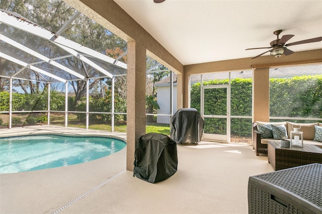 outdoor pool with a patio area, ceiling fan, area for grilling, and an outdoor hangout area