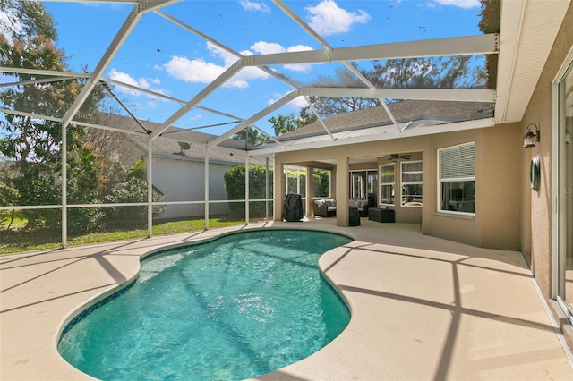 outdoor pool featuring a lanai, a patio area, and a ceiling fan