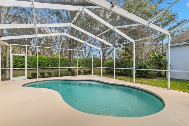 outdoor pool with a lanai and a patio area