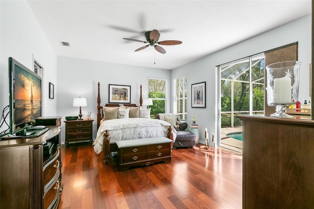 bedroom with visible vents, baseboards, ceiling fan, dark wood-style flooring, and access to exterior