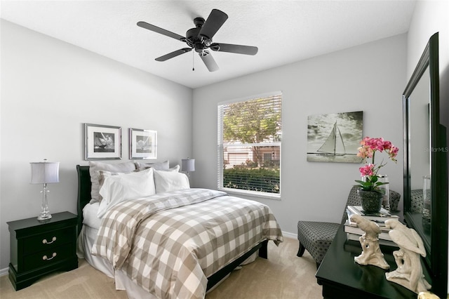 bedroom with light carpet, ceiling fan, and baseboards