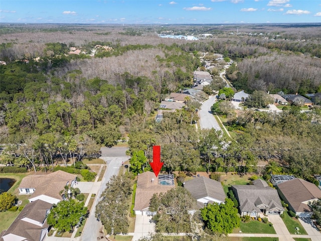 birds eye view of property featuring a forest view and a residential view