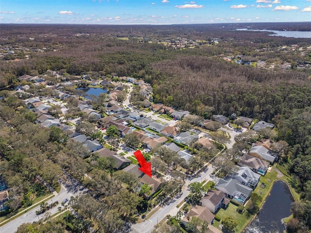 aerial view with a residential view, a water view, and a wooded view