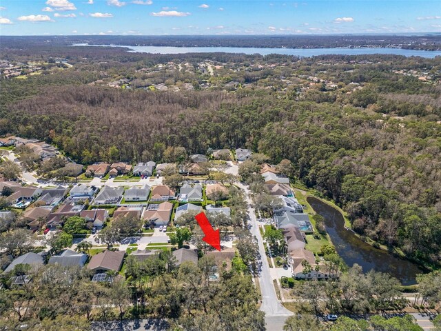 bird's eye view with a water view, a forest view, and a residential view