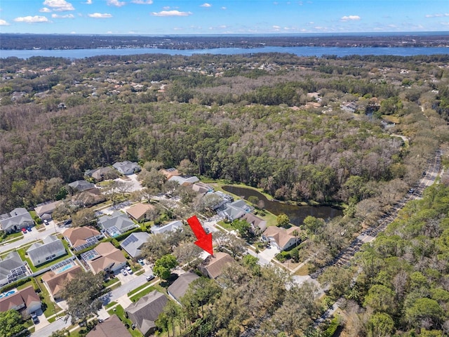 aerial view with a residential view, a water view, and a forest view