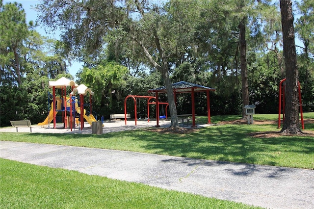 community jungle gym featuring a lawn